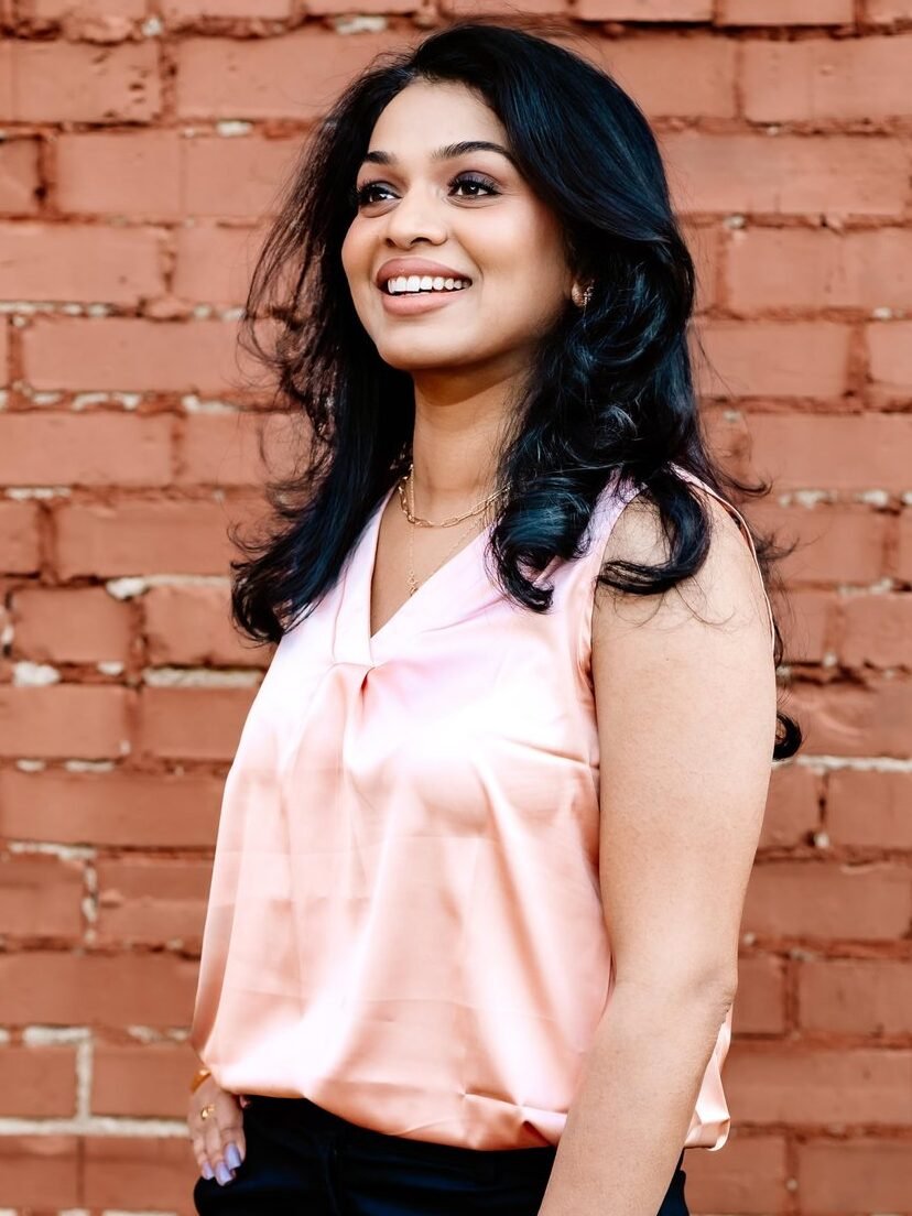 Dr. Shilpa Gadde, founder of ProMedicaMD, standing in front of a brick wall